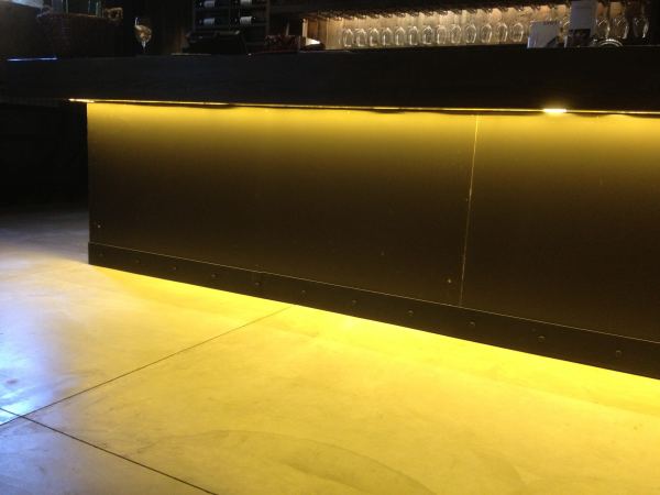 Metal Trim — Black magic patina applied to steel baseboard at wine bar.
