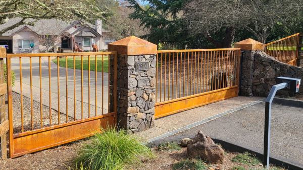 Single Swing Driveway Gate — Single swing driveway gate for a refined, cohesive entry system, features: 2" x 2" x .188 gate frame 3/4" x 3/4" x .090 square tube pickets Rust finish