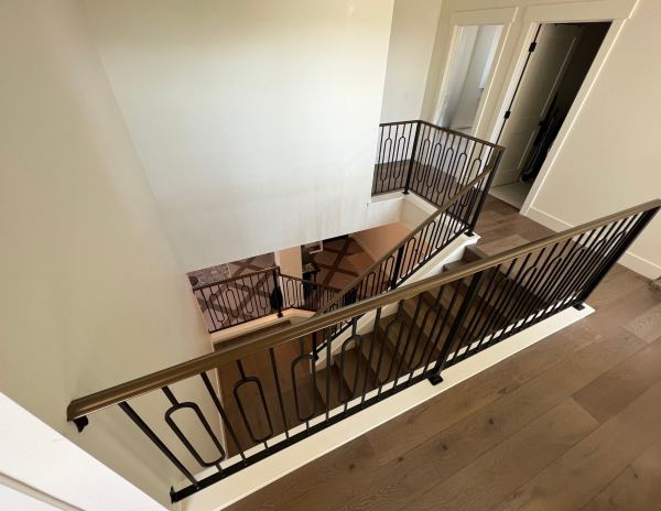 Contemporary Railing — This elegant contemporary railing with a bronze color top cap features: 2-1/4" decorative molded rail cap w/ lamb's tongue terminations 1-1/2" x 1 1/2" x .120" tube steel posts 1/2" x 1/2" decorative single oval balus...