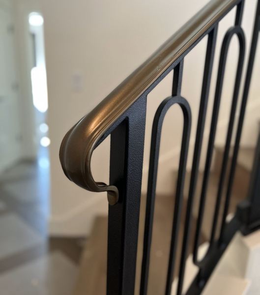 Contemporary Railing — This elegant contemporary railing with a bronze color top cap features: 2-1/4" decorative molded rail cap w/ lamb's tongue terminations 1-1/2" x 1 1/2" x .120" tube steel posts 1/2" x 1/2" decorative single oval balus...