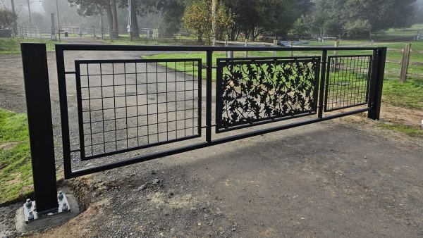 Decorative Driveway Gate — Custom driveway gate designed to combine security with decorative artistry, featuring: 2” x 2” x .188” tube steel frame 1” x 1” x .120” tube steel inner frames Decorative oak leaf pattern panel Welded wire mesh in...