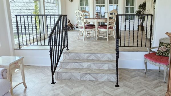 Ornamental Interior Handrail — Ornamental interior handrail, featuring: 1 1/2" x 1/2" flat bar underlayment 1 3/16" square hammered posts with center knuckle posts Top mounted with cover shoes BK08 black powder coat finish